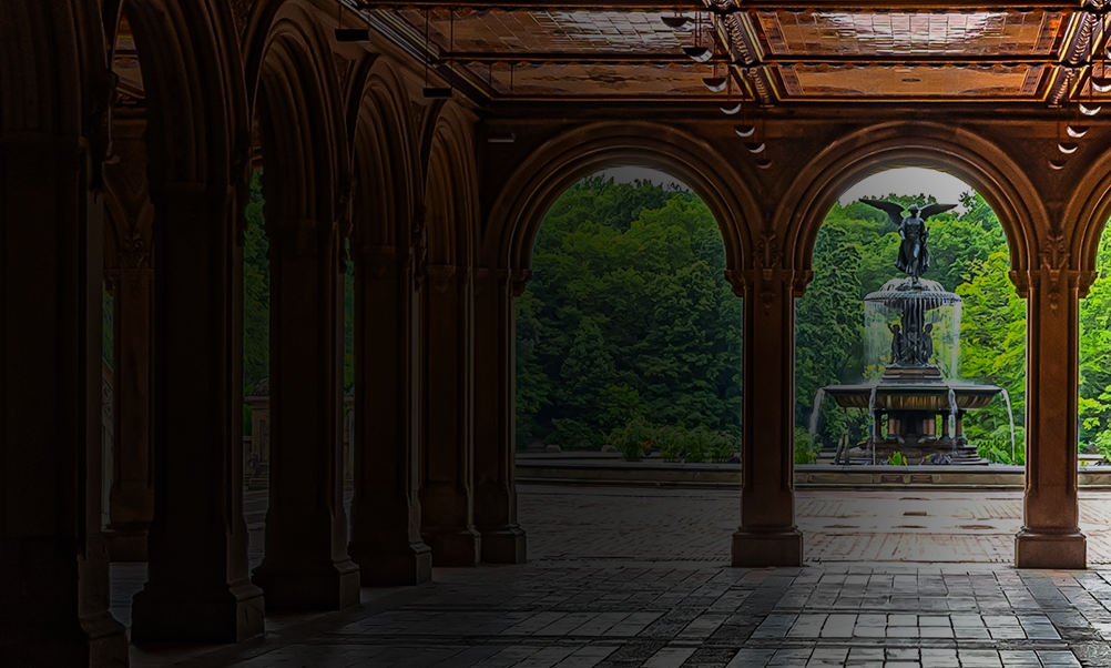 Grand architectural pavilion with vaulted arches and tiled flooring framing a decorative fountain surrounded by vibrant trees and landscaped gardens, creating a romantic city park atmosphere.