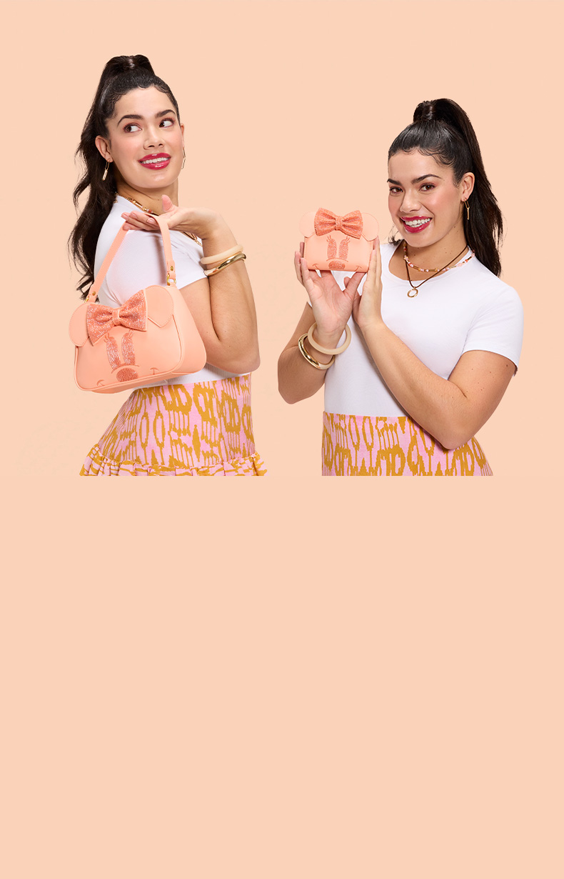 Pink background with model showcasing Loungefly Minnie Mouse accessories