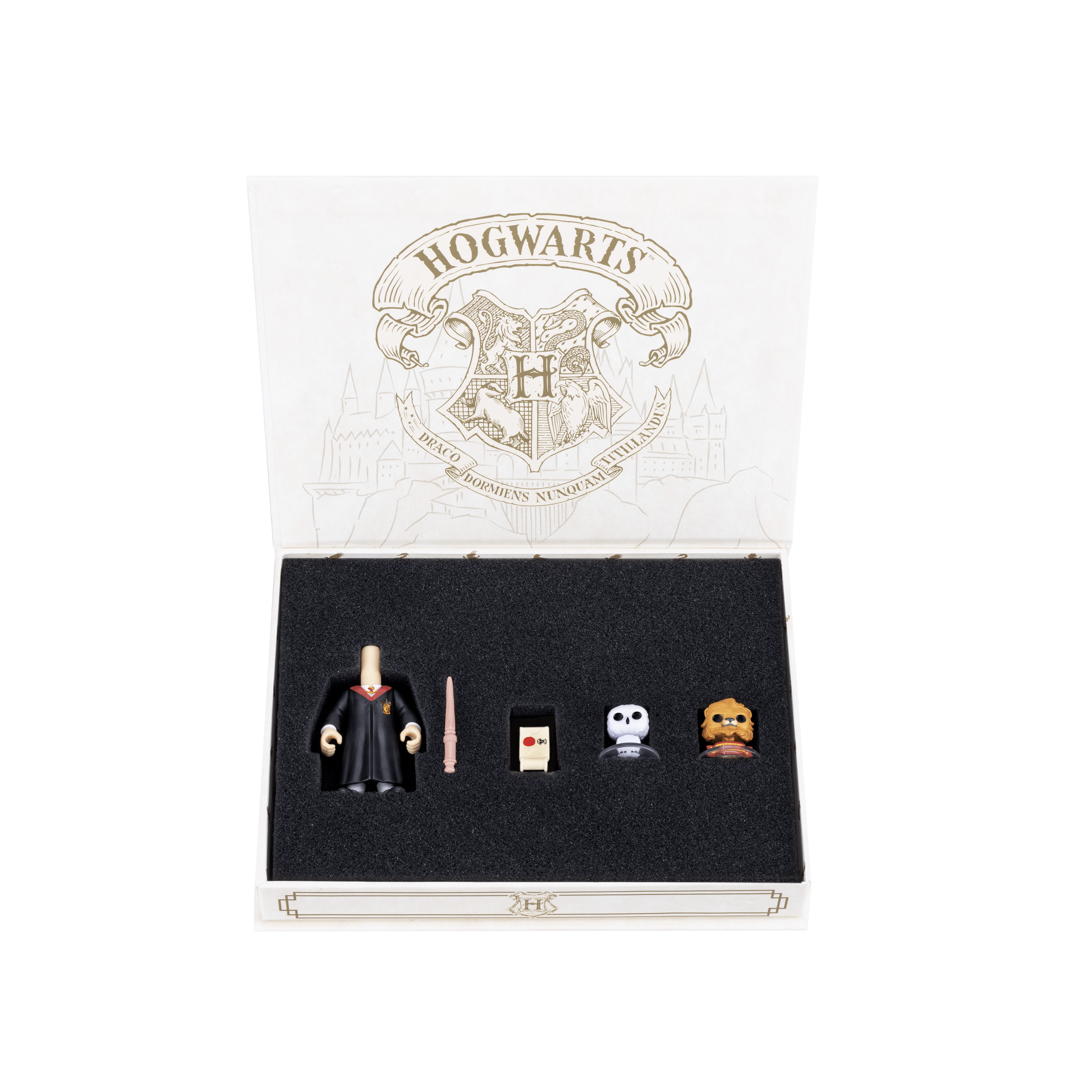 Gryffindor trunk-inspired box with the  lid open revealing the black velvet interior and the items secured into place, including the body with the robe, the mascot, the snowy owl, the light brown wand, and the sealed Hogwarts acceptance letter.