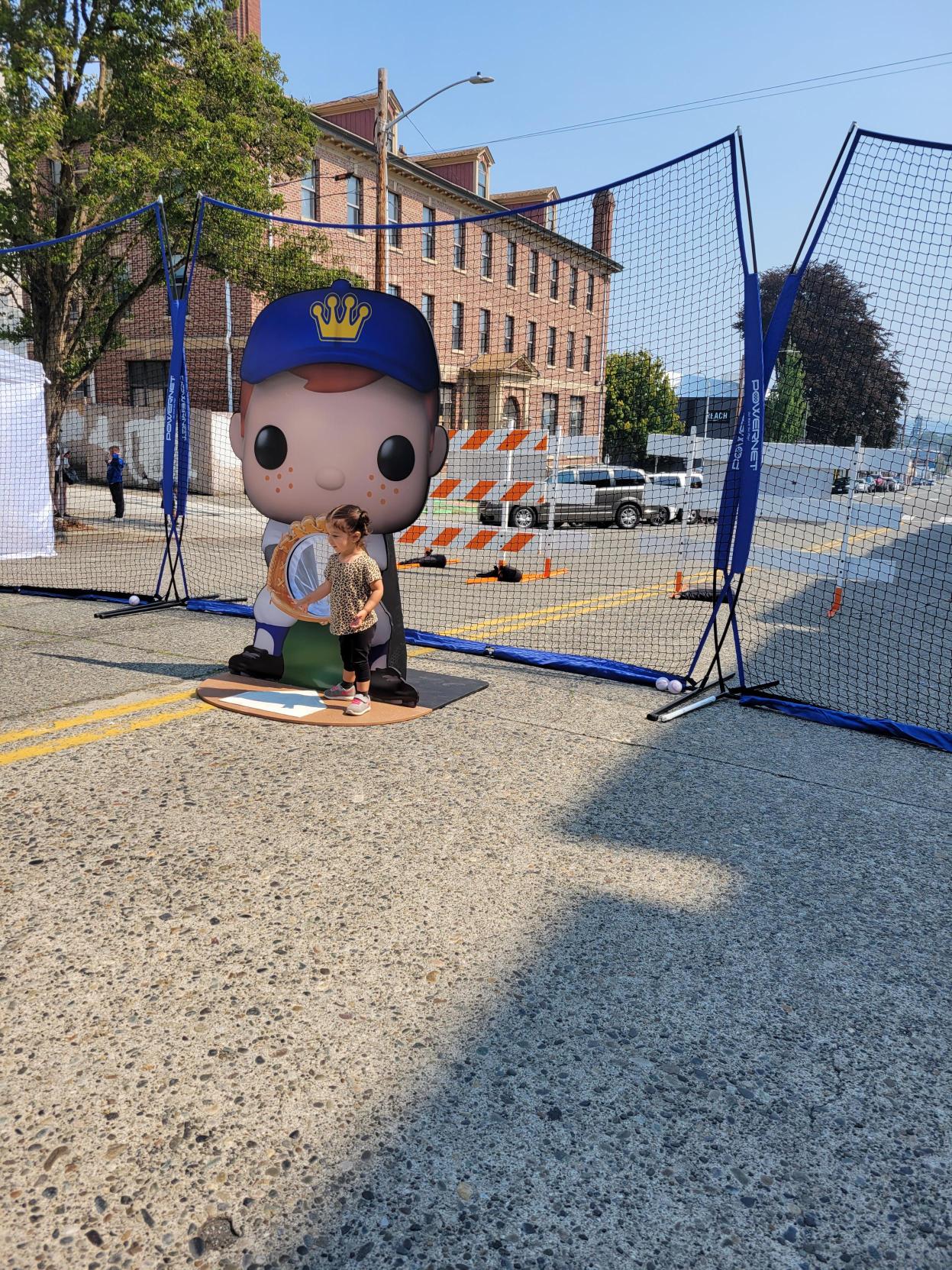 Baseball Freddy Funko Cut-out: A child stands in front of a life-sized Freddy Funko cut-out. Freddy has a catcher’s mitt and is ready for the next throw.
