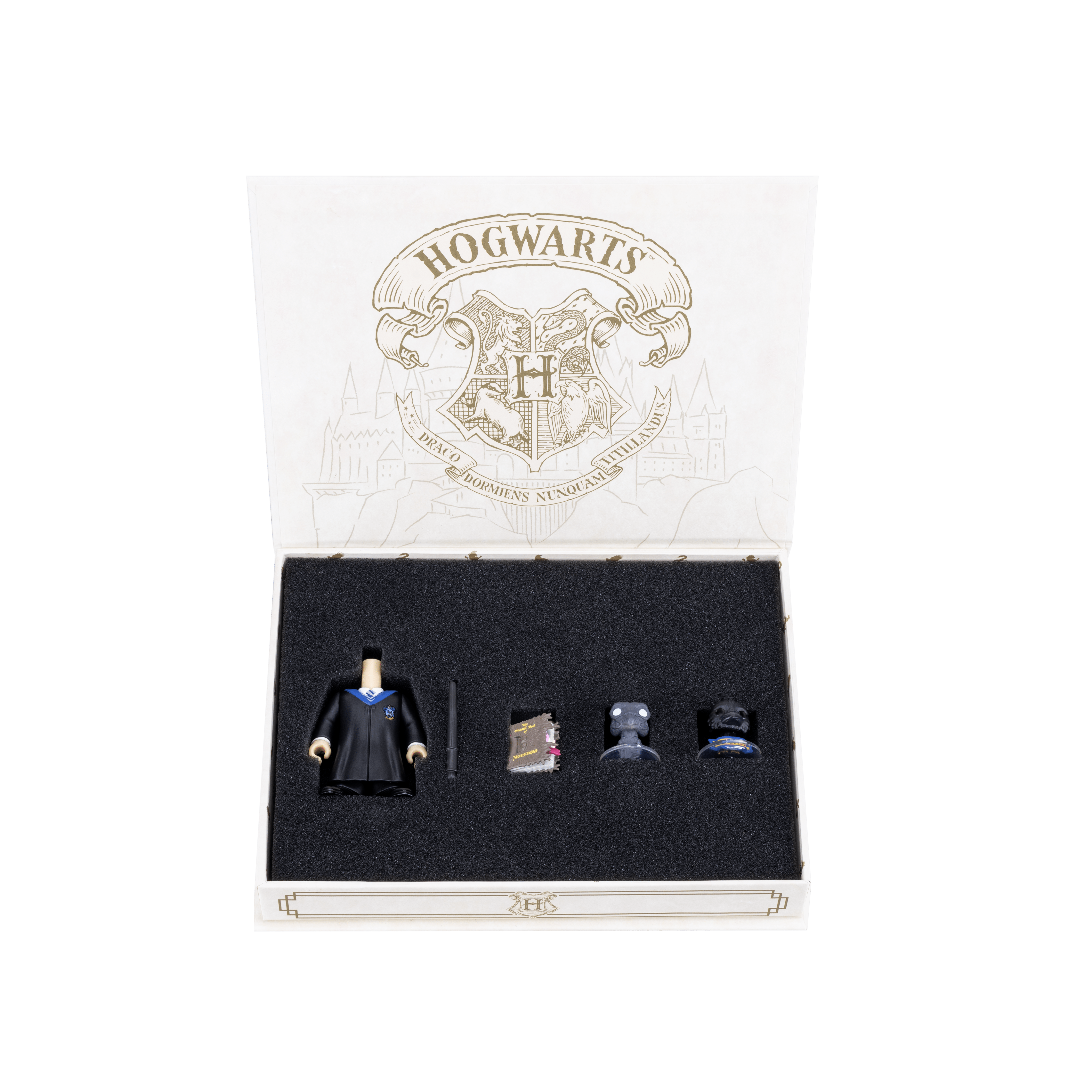 Ravenclaw Accessory Pack box with the lid open, revealing all items secured inside the velvet lining. Items include a body and robe, a dark brown wand, the mascot, a Thestral, and the Monster Book of Monsters