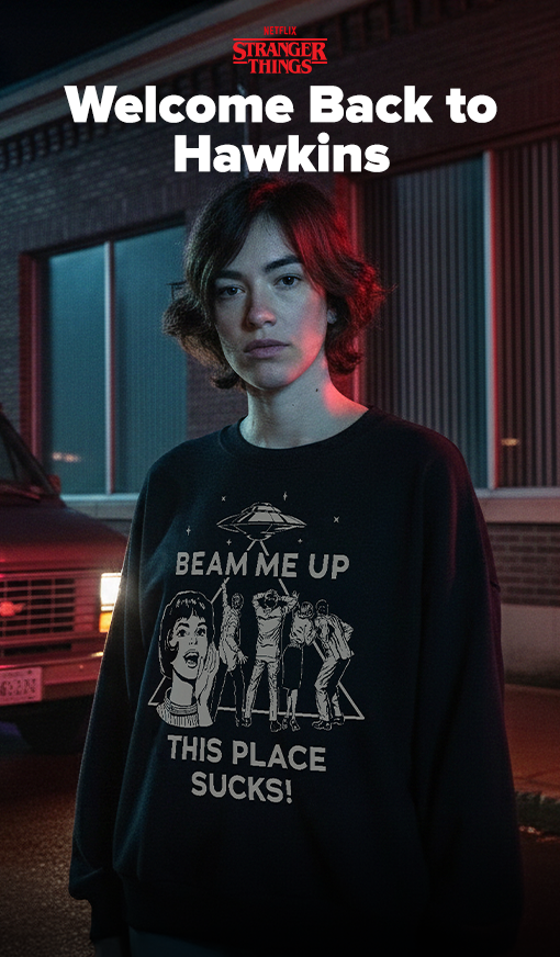 Grungy model background with van and headlights on featuring model wearing Stranger Things apparel with White text that reads "Welcome Back to Hawkins" and the Netflix Stranger Things logo