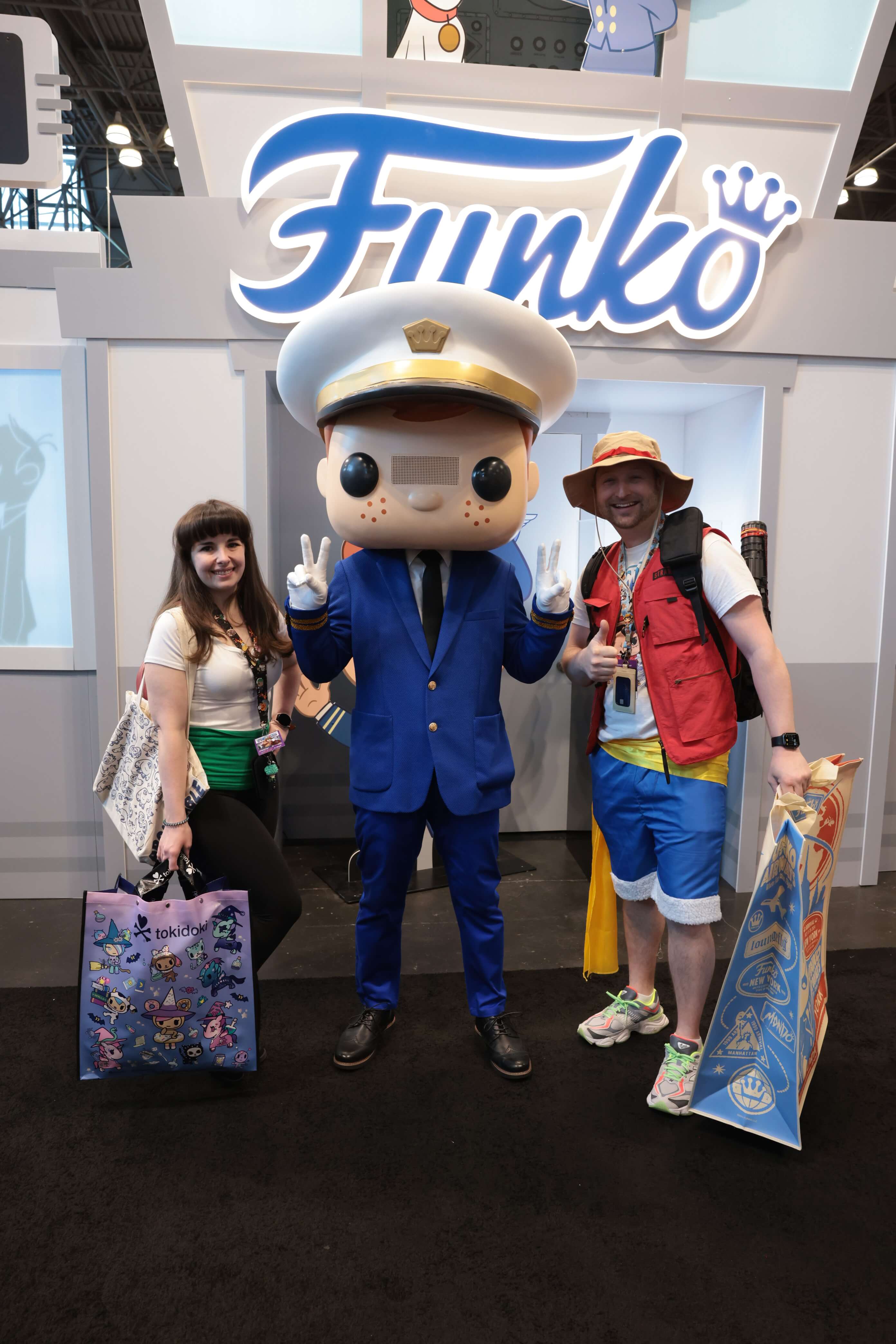 Freddy Funko with two cosplaying fans.