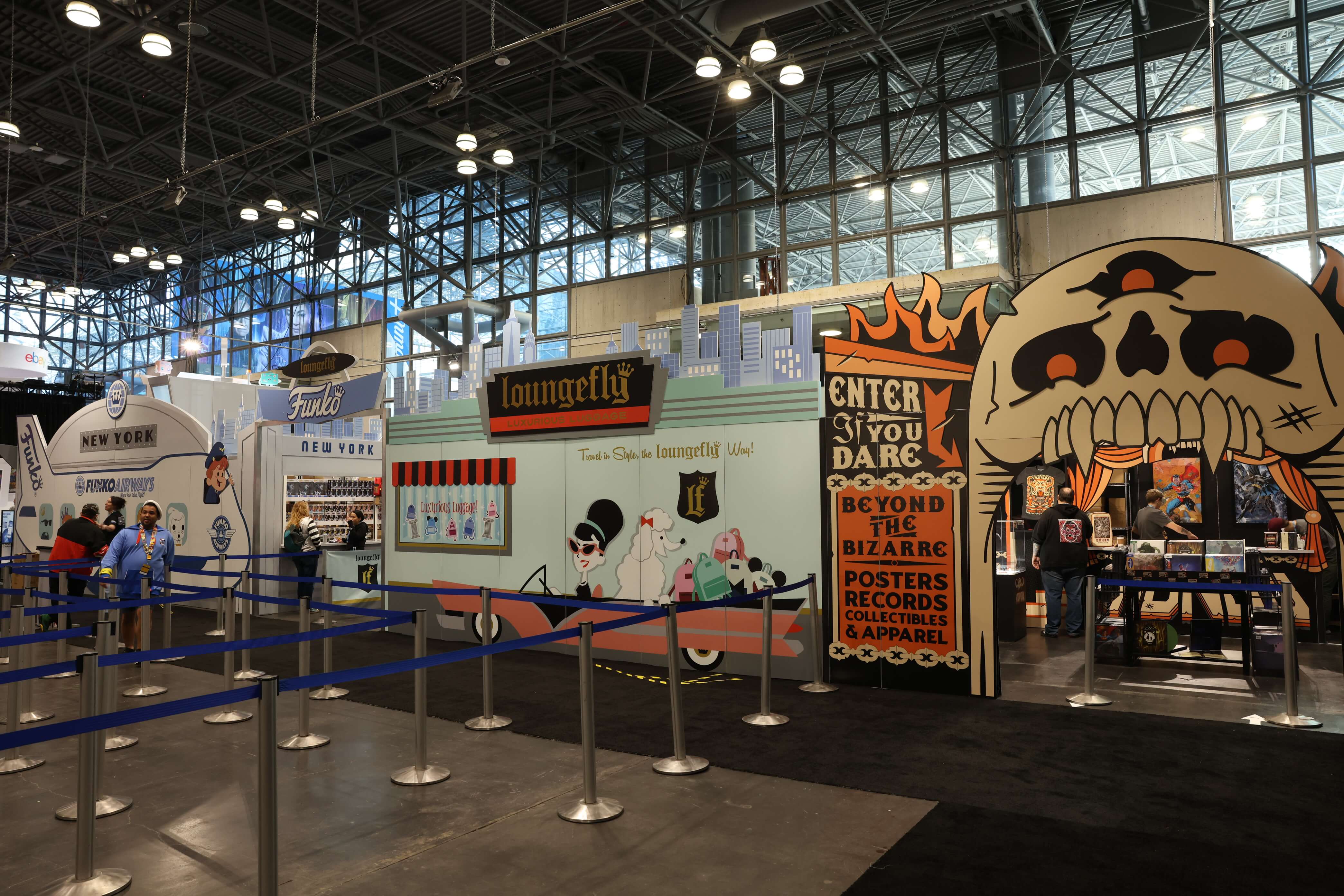 Loungefly and Mondo Booths. Loungefly's looks like a boutique and Mondo's is horror themed with a giant skull with teeth cutout revealing the store inside.