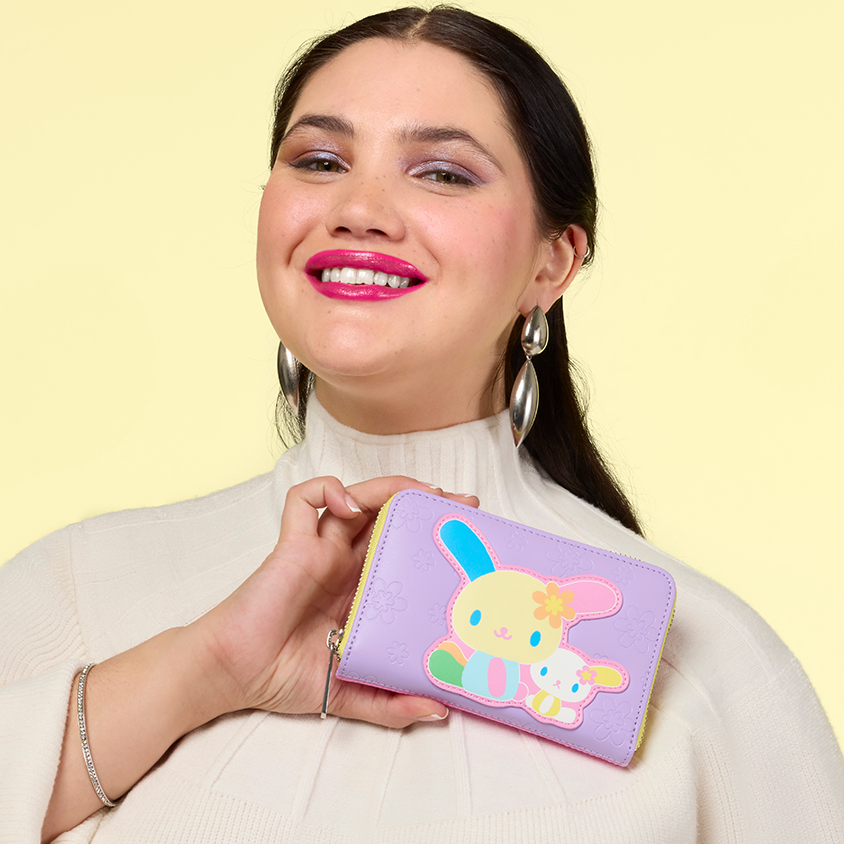 Yellow background with model showcasing Loungefly Sanrio wallet