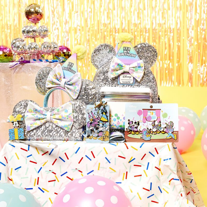 Birthday party decor accompanies the Loungefly Mickey Mouse and Friends Birthday Celebration collection. The headband, wallet, crossbody bag, and backpack feature shiny silver sequins, party hats, and mouse ears.