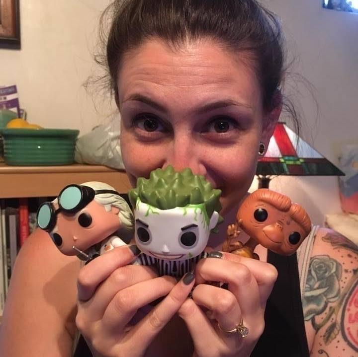 Sarah Scherer, in 2016, with her first three Pop! figures (Pops! Dr. Emmett Brown, Beetlejuice, and E.T.) right after she found out that she got a job with Funko. Fun fact: That E.T. figure was given to her in her interview!