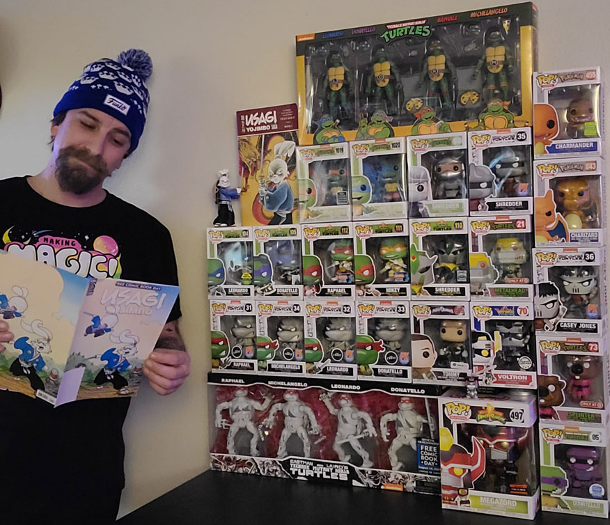 Garret reads a Usagi Yojimbo comic in front of his Teenage Mutant Ninja Turtles collection