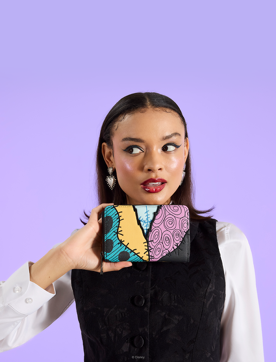 Purple background with model showcasing Loungefly Nightmare Before Christmas wallet