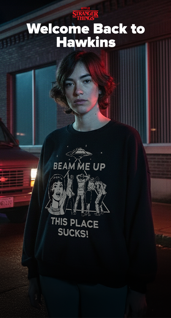 Grungy model background with van and headlights on featuring model wearing Stranger Things apparel with White text that reads "Welcome Back to Hawkins" and the Netflix Stranger Things logo