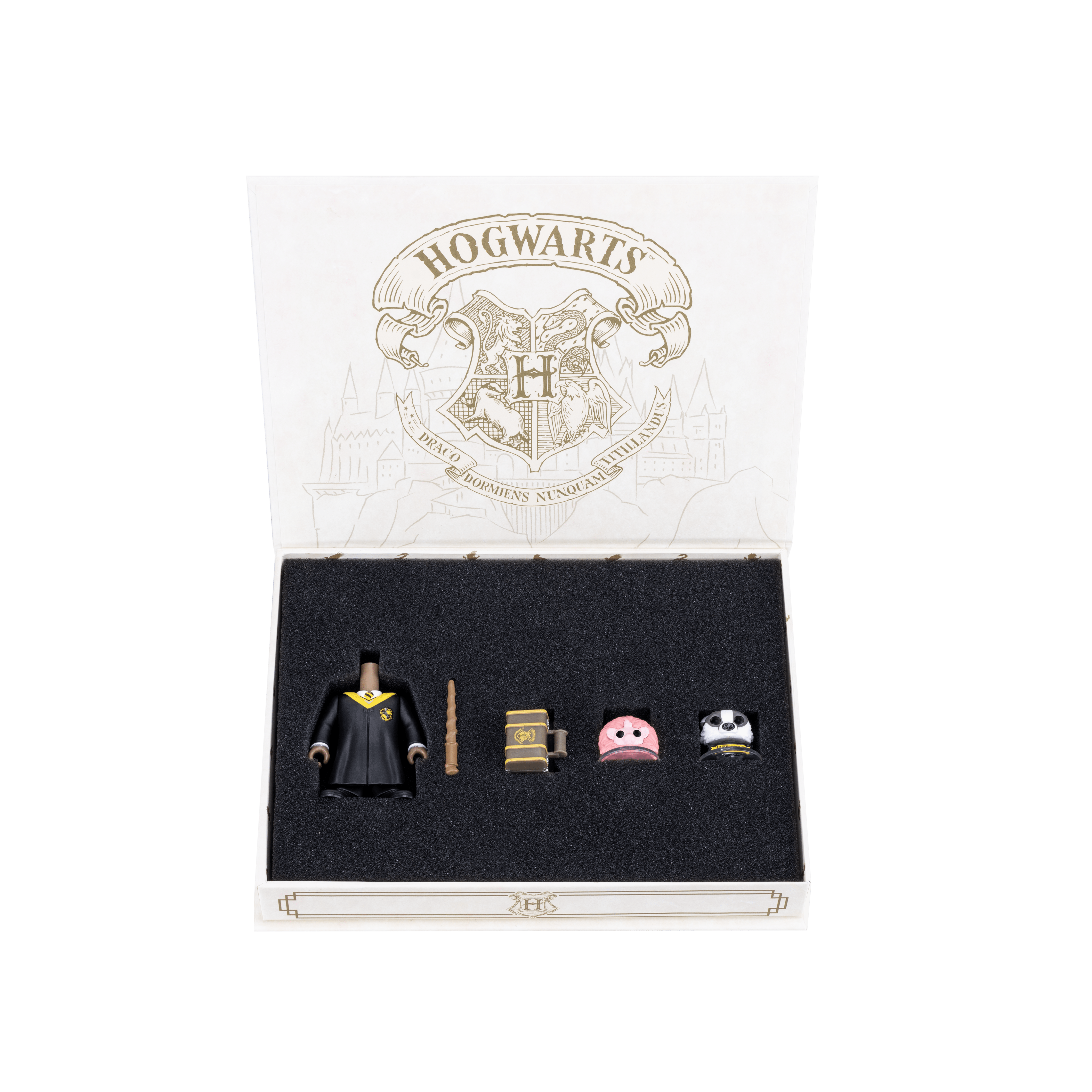 Hufflepuff Accessory Pack with Hufflepuff accessories secured inside, including the mascot, body with robe, a Pygmy Puff, brown wand, and Hogwarts trunk
