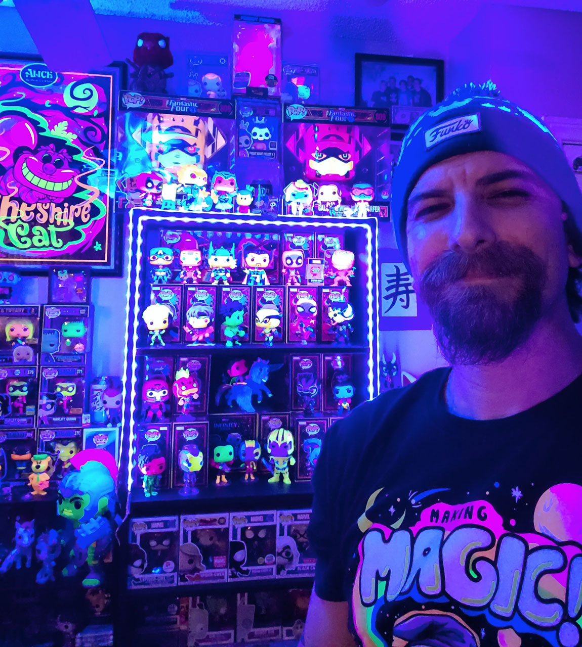 Garret smiling in front of his blacklight collection