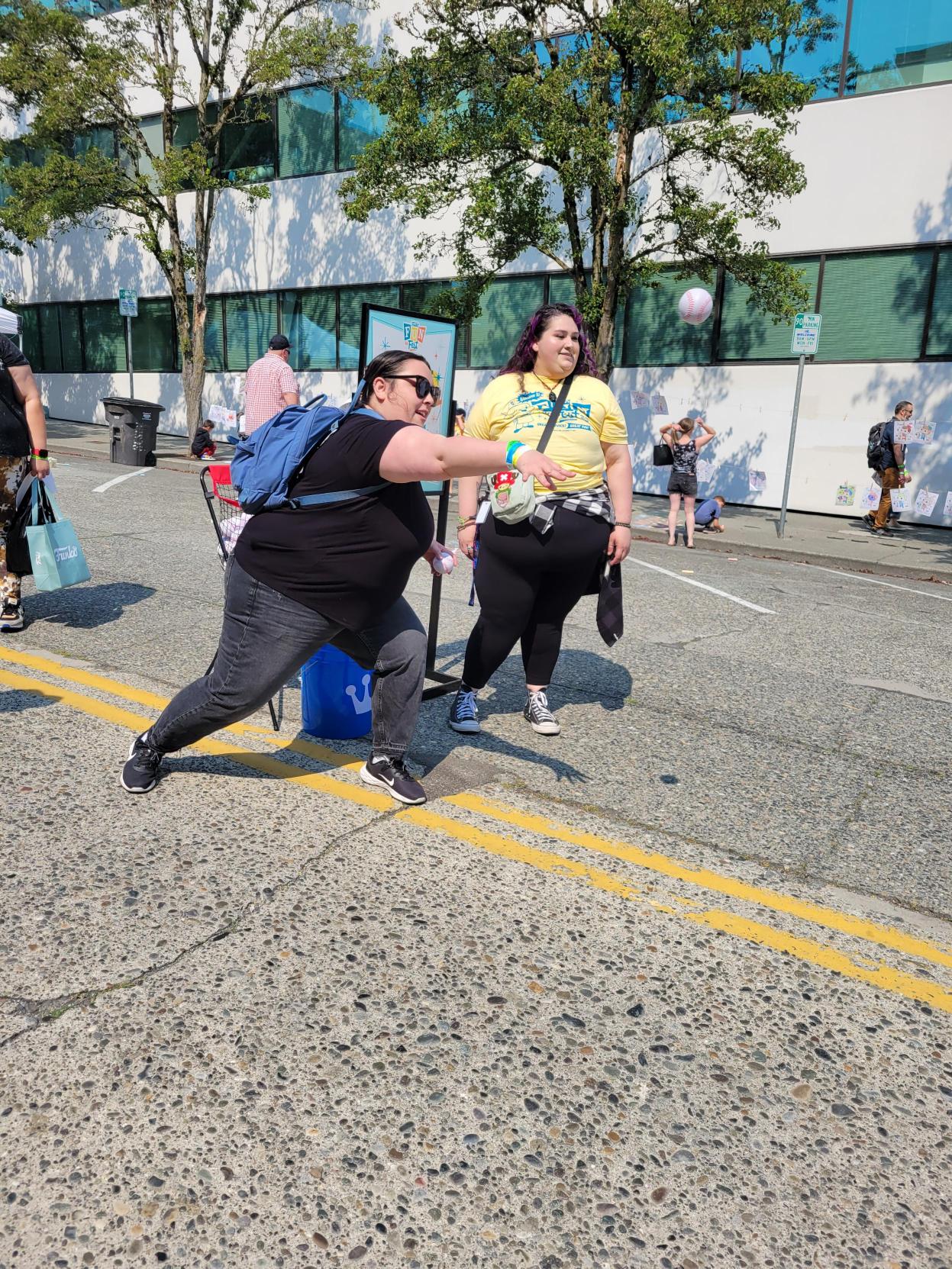 Ball Toss: Two Funatics throw a ball across the street in the hopes of making it all the way to the Freddy Funko baseball target.