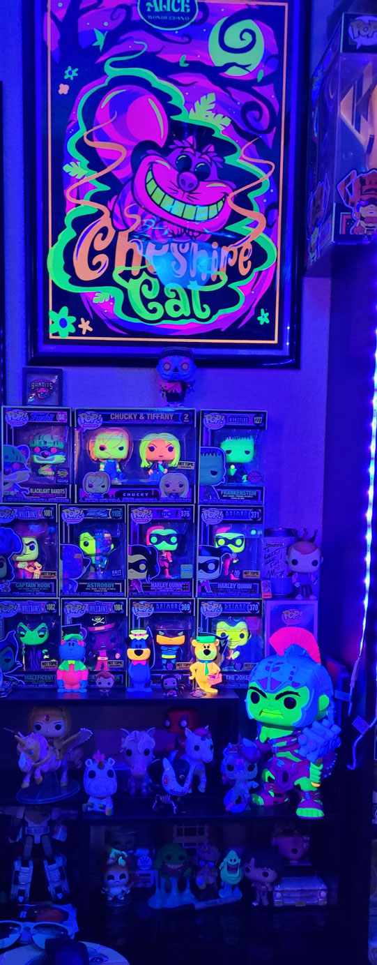 Garret's blacklight collection with Cheshire Cat Poster