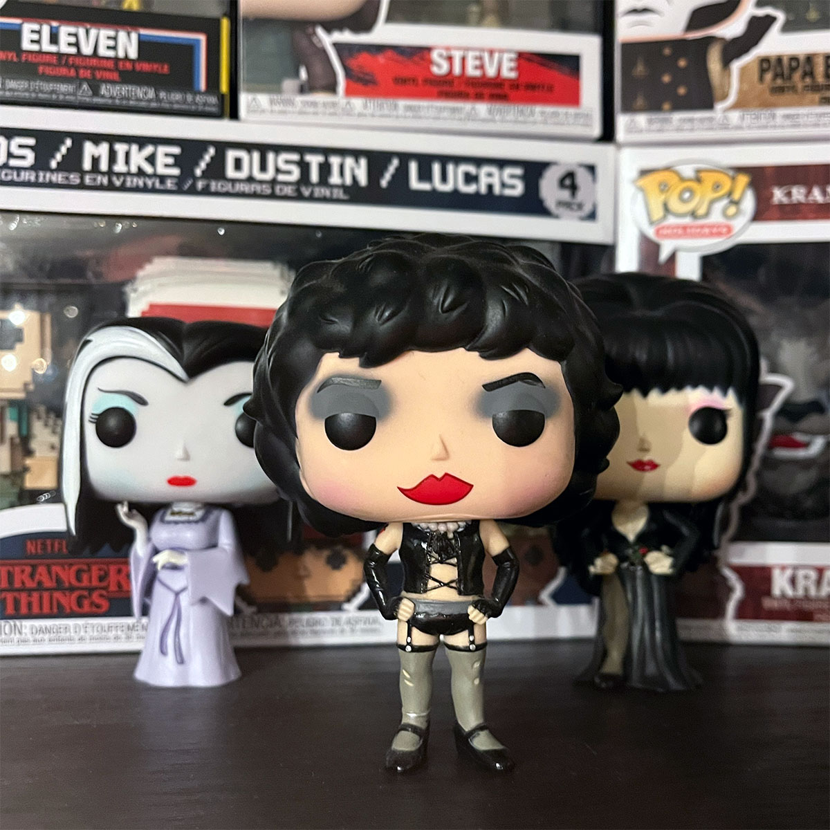 Jamie Pearson's Funko Pops!, including Dr. Frank-N-Furter, Lily Munster, and Elvira, all placed before a selection of Pop! boxes.